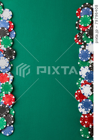 Pile of Casino pocker gambling chips on green table 79796408