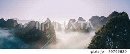 Aerial panorama view of beautiful sunrise over karst mountain peak landscape Aerial panorama view of beautiful sunrise over karst mountain peak landscape 79796620