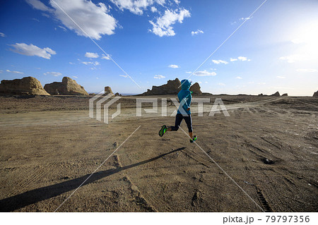 Fitness woman trail runner cross country running  on sand desert 79797356