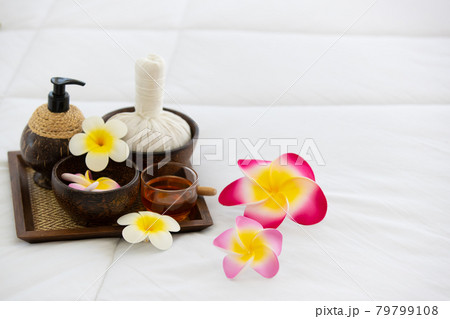 Set of spa treatments, natural oil, and plumeria flowers Set of spa treatments, natural oil, and plumeria flowers 79799108