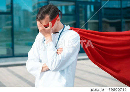 superhero doctor standing near the entrance to the hospital. 79800712