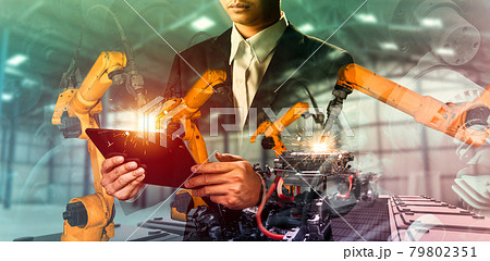 Mechanized industry robot arm and factory worker double exposure 79802351