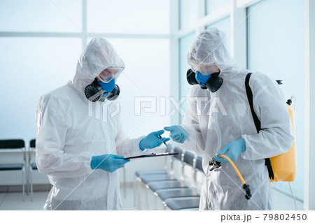 team of professional disinfector discussing the work done . team of professional disinfector discussing the work done . 79802450