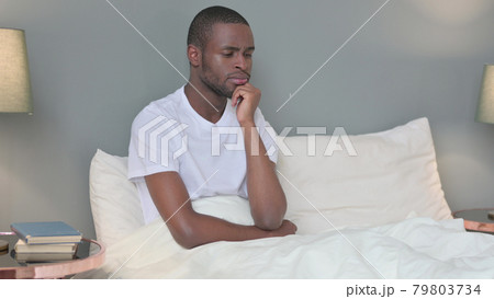 Pensive Young African Man Thinking in Bed  79803734
