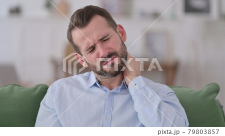 Young Man with Neck Pain at Home  79803857