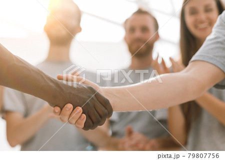 close up. handshake of two students on the background of the st close up. handshake of two students on the background of the st 79807756