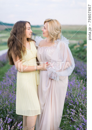 Mother and daughter in lavender field on beautiful summer day Mother and daughter in lavender field on beautiful summer day 79807867
