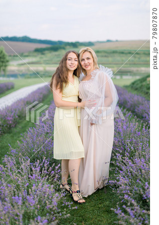 Mother and daughter in lavender field on beautiful summer day Mother and daughter in lavender field on beautiful summer day 79807870