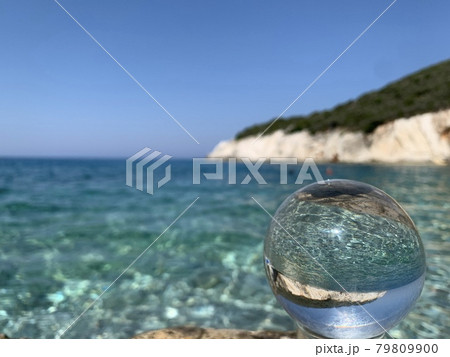 close up crystal glass ball at the beach. close up crystal glass ball at the beach. 79809900