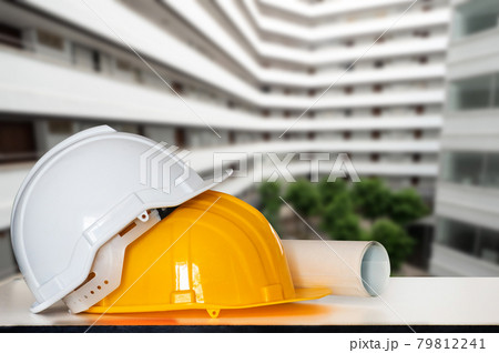 Construction house and building. Repair work. Drawings for building and helmet on table.. Construction house and building. Repair work. Drawings for building and helmet on table.. 79812241