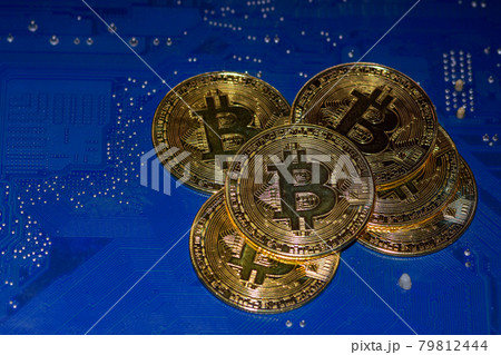 Bitcoin golden coins on a printed circuit board. Bitcoin concept Bitcoin golden coins on a printed circuit board. Bitcoin concept 79812444