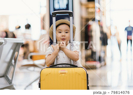 Little girl waiting at the airport Little girl waiting at the airport 79814076