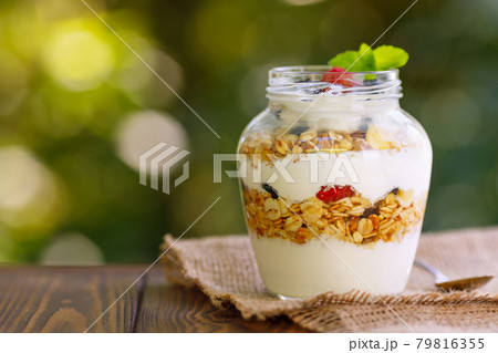 granola with greek yogurt and berries in glass jar granola with greek yogurt and berries in glass jar 79816355