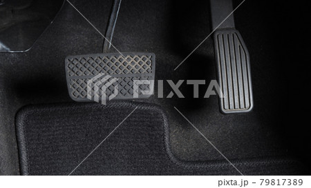 Man foot and accelerator and brake pedal inside the car or vehicle and copy space which black color leather shoe stepped on it for speed up or control automobile pace power. Automobile Driving concept Man foot and accelerator and brake pedal inside the car or vehicle and copy space which black color leather shoe stepped on it for speed up or control automobile pace power. Automobile Driving concept 79817389