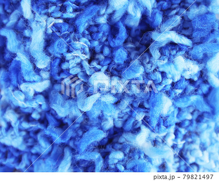 Natural woolen fabric fragment. Knitted texture closeup. Warm yarn background. 79821497