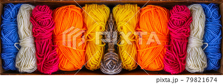 Colorful skeins of yarn in old wooden vintage box close up. 79821674