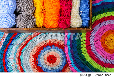 Knitted mat and colorful skeins of wollen yarn 79821692
