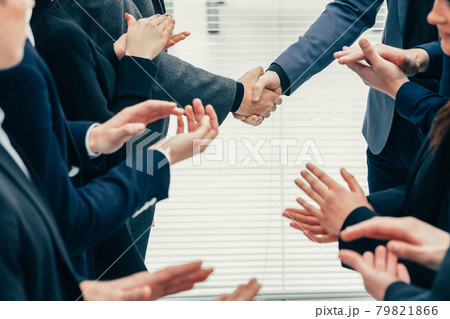 financial partners are shaking hands with each other . financial partners are shaking hands with each other . 79821866