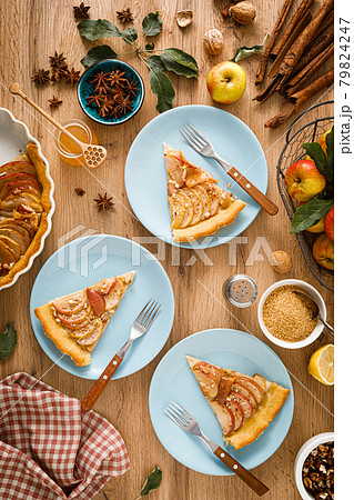 Thanksgiving autumn apple pie with fresh fruits and walnuts on wooden table, top view Thanksgiving autumn apple pie with fresh fruits and walnuts on wooden table, top view 79824247