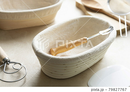 Rattan banneton, proofing basket for sourdough bread. Baking utensile. Basic set of baking bread at home. Rattan banneton, proofing basket for sourdough bread. Baking utensile. Basic set of baking bread at home. 79827767