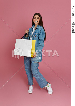 beautiful woman holding shopping bags with purchases 79831476