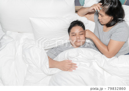 Mother measuring temperature of his ill kid. Sick child concept. Mother measuring temperature of his ill kid. Sick child concept. 79832860