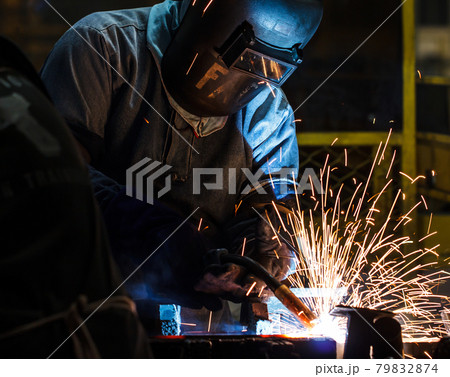 welder with protective equipment in factory welder with protective equipment in factory 79832874