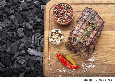 Piece of cooked rump steak with spices served 79833193