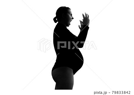Screaming angry young pregnant woman. Silhouette view 79833842