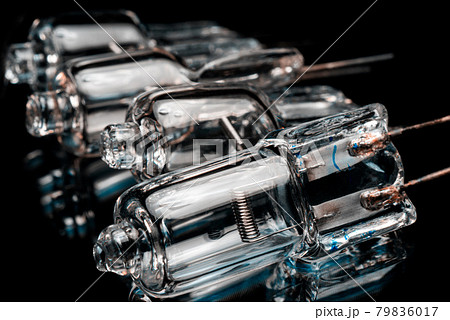 Several halogen small incandescent lamps with a blurry background Several halogen small incandescent lamps with a blurry background 79836017