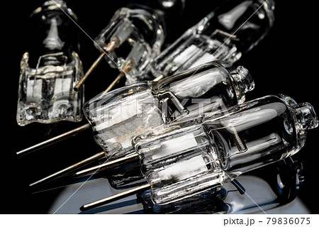 Several halogen small incandescent lamps with a blurry background 79836075