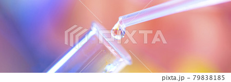 Chemical test tube and pipette with a drop of liquid in a chemical laboratory. A baby is reflected in a drop of liquid. Fertilization concept 79838185