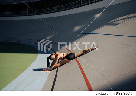 Young attractive female fitness woman performing a twine 79838679
