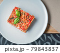 Piece of delicious lasagna with basil leaf on 79843837