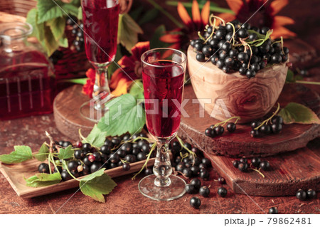Black currant liquor and ripe juicy berries. 79862481