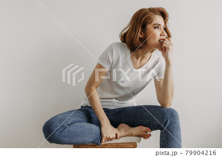 Cool looks woman in white t-shirt and jean relax in her apartment room. 79904216