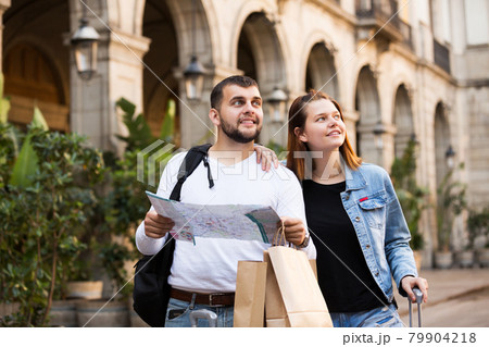 Tourists walking with map at street 79904218