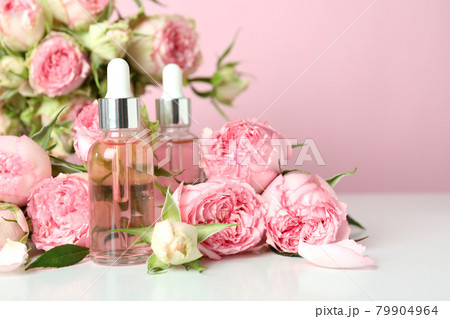 Skin care concept with essential rose oil on pink background 79904964
