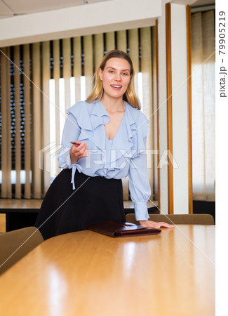 Business woman posing in her office Business woman posing in her office 79905219