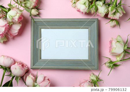 Roses and empty frame on pink background 79906132