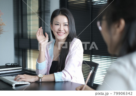 Two  businesspeople are using tablet and discussing work at office. 79906342