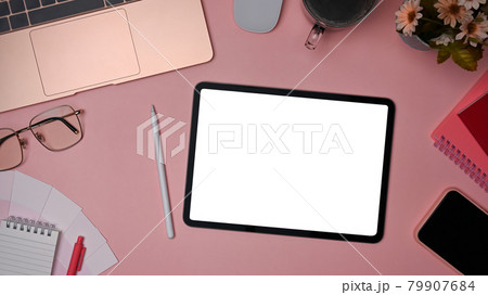 Top view female workspace with laptop computer, digital tablet and office supplies on pink background. 79907684