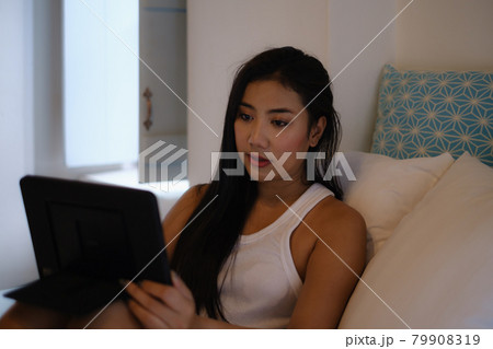 A woman lying on couch and using tablet. Work from home concept A woman lying on couch and using tablet. Work from home concept 79908319