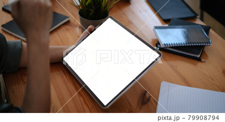 Mockup digital tablet on businesswoman hand with blank screen. Business people meeting and brainstorming by video conference. Mockup digital tablet on businesswoman hand with blank screen. Business people meeting and brainstorming by video conference. 79908794