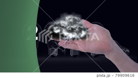 Dark clouds over hand over multiple light bulbs against green technology background Dark clouds over hand over multiple light bulbs against green technology background 79909616