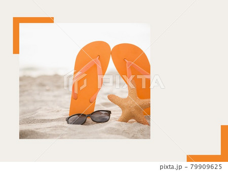 Photograph of flip flops, sunglasses and starfish at the beach against grey background Photograph of flip flops, sunglasses and starfish at the beach against grey background 79909625