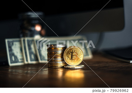 gold bitcoins placed on a wooden desk 79926962