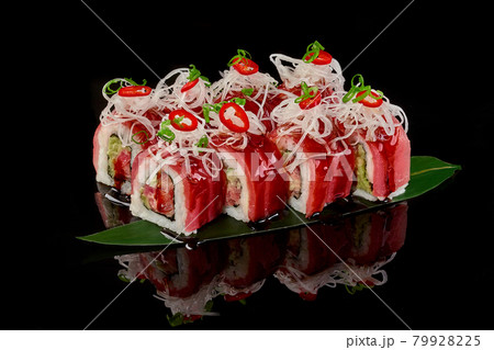 Sushi rolls with tuna, unagi sauce, daikon on bamboo leaf Sushi rolls with tuna, unagi sauce, daikon on bamboo leaf 79928225