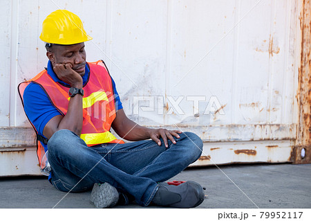 African American foreman or container worker sit and look like sleep to relax after finish his work 79952117