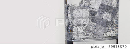 Closeup of glass with mineral water and ice Closeup of glass with mineral water and ice 79953379